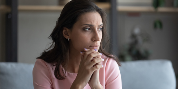 Upset young woman on couch