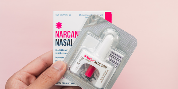 Hand holding Narcan